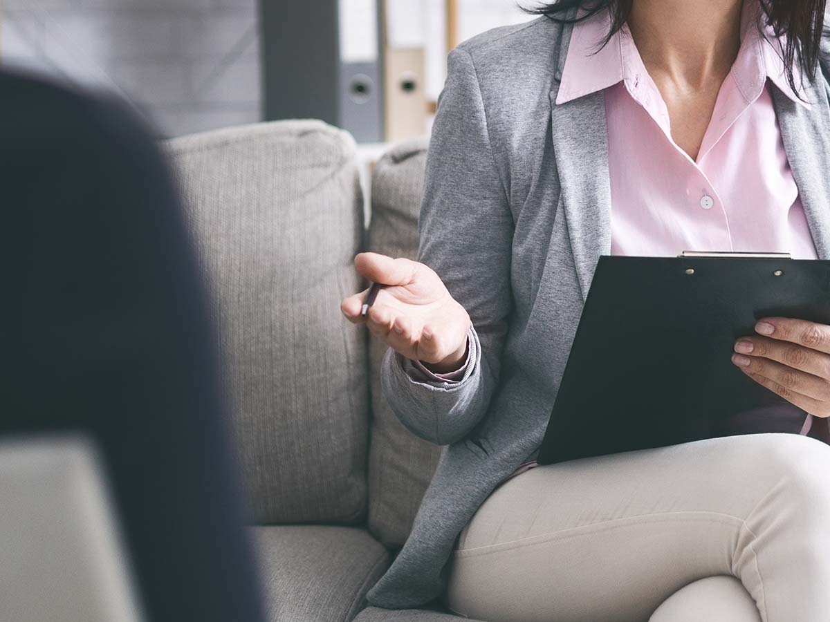 Therapist holding clipboard during a session.